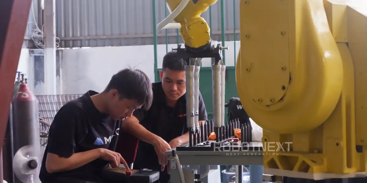 Kỹ sư của Robotnext đang lập trình robot mài phôi nhôm bằng tay dạy tích hợp